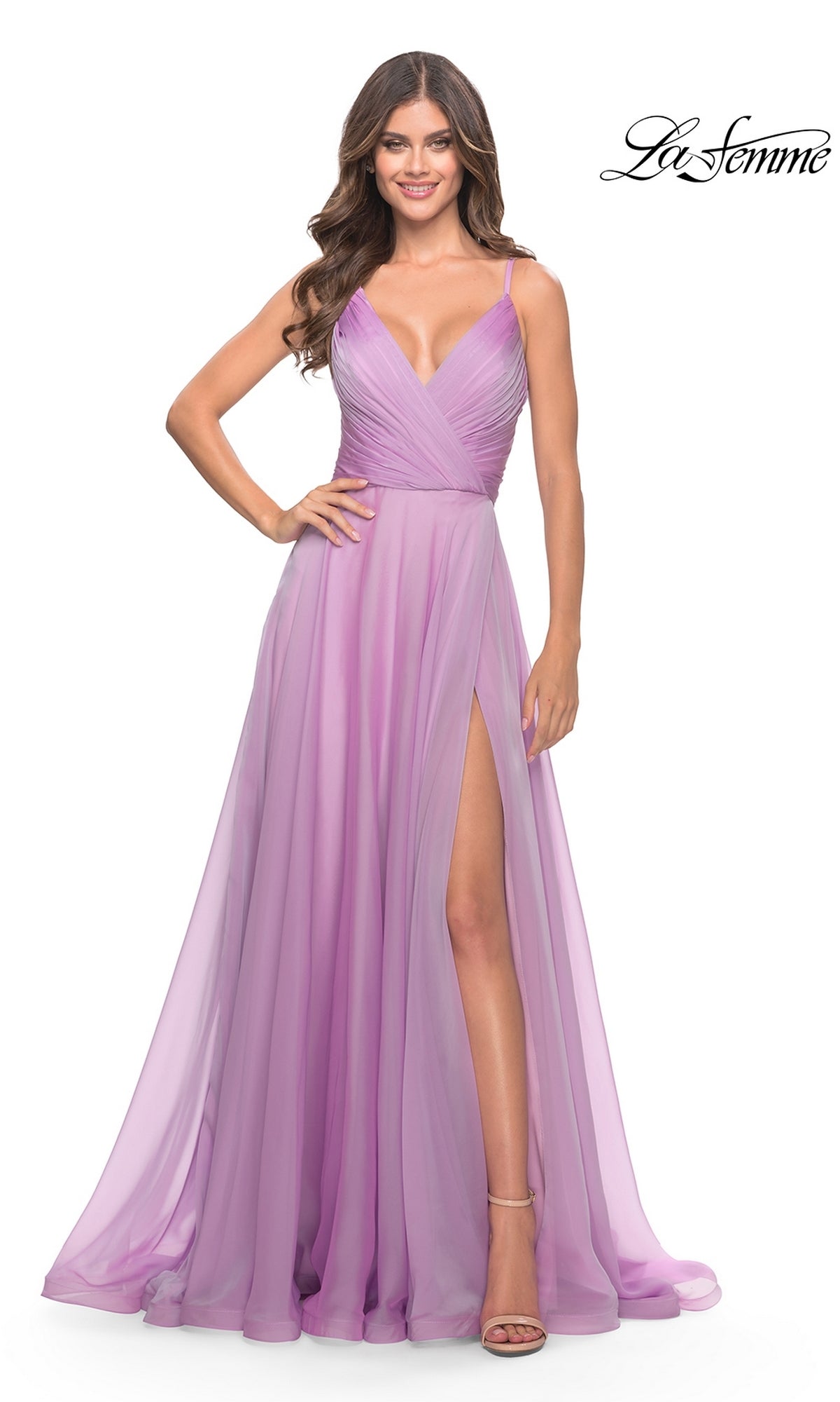 A woman poses with one hand on her hip in the La Femme V-Neck Long A-Line Prom Dress 31500—a sleeveless, floor-length light purple gown with a high slit and V-neckline. The La Femme logo appears in the top right corner.